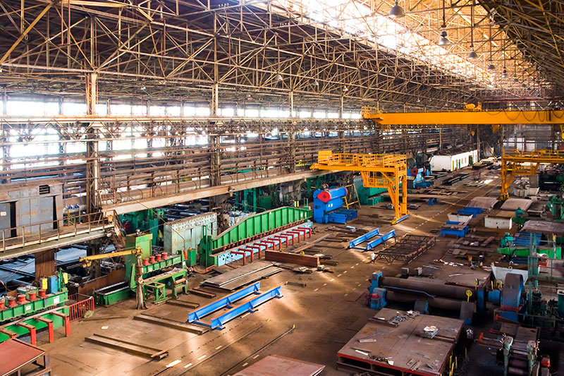 Large industrial manufacturing facility interior with heavy machinery